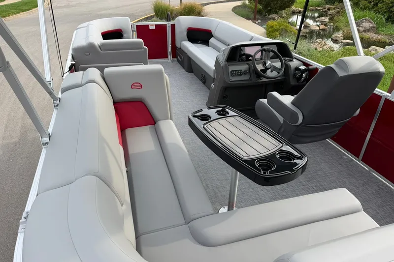 Slide: The Image of 2027 Sun Tracker Party Barge 20 DLX interior with plush seating and modern helm. - 20