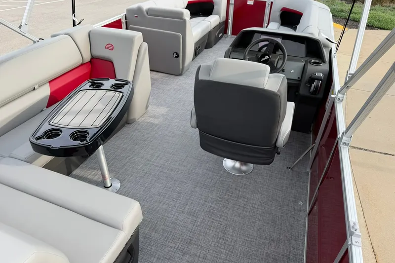 Slide: The Image of 2027 Sun Tracker Party Barge 20 DLX interior with seating and steering console. - 21