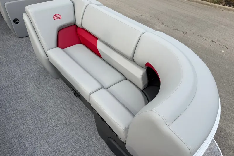 Slide: The Image of 2027 Sun Tracker Party Barge 20 DLX, gray and red seating, on a pontoon boat deck. - 13