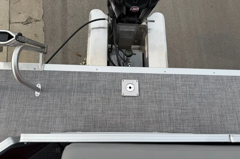 Slide: The Image of 2027 Sun Tracker Party Barge 20 DLX pontoon boat deck with motor view. - 19