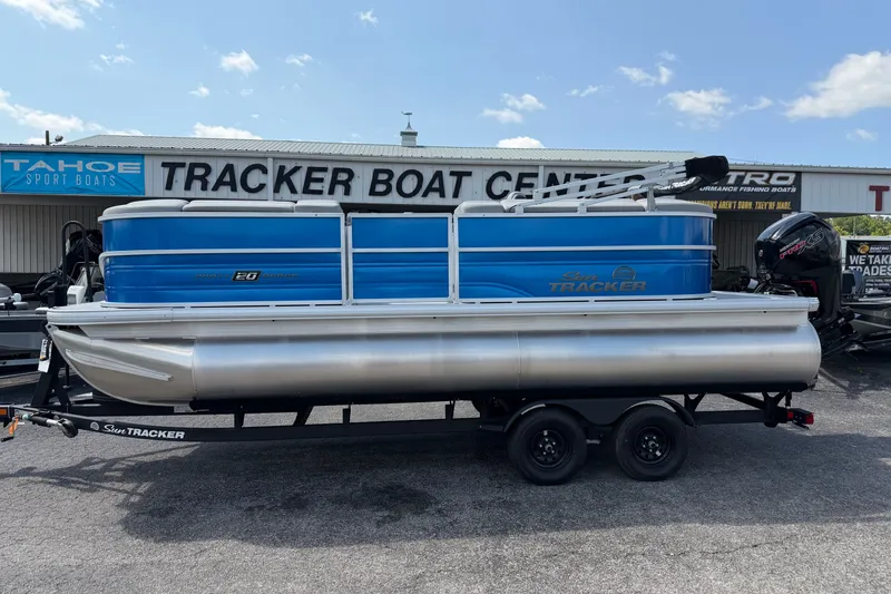 The Image of 2027 Sun Tracker Party Barge 20 DLX pontoon boat on trailer at dealership. - 0