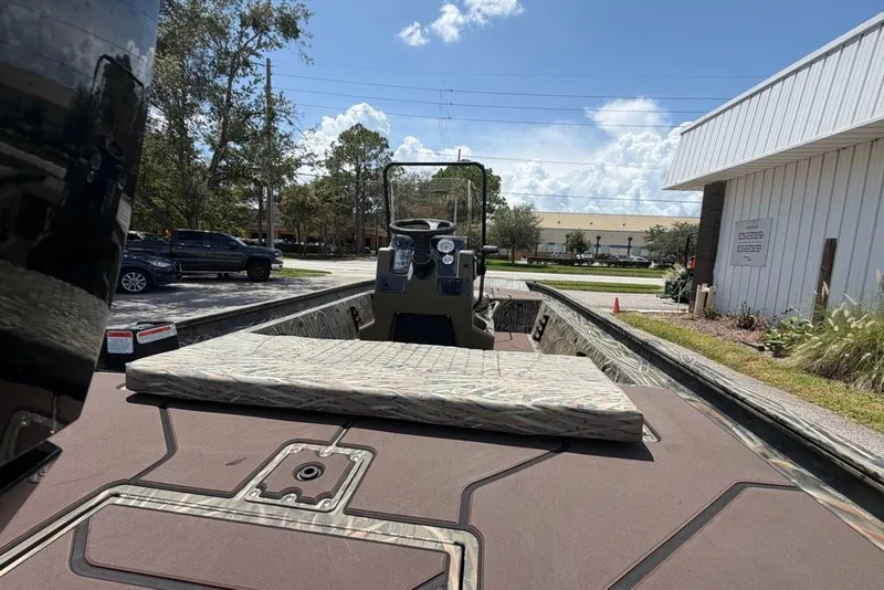 Slide: The Image of 2027 Tracker Grizzly 1860 CC boat parked outdoors on a sunny day. - 73
