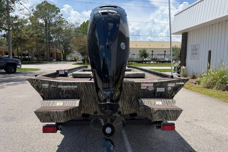 Slide: The Image of 2027 Tracker Grizzly 1860 CC boat with camo design and powerful outboard motor. - 62