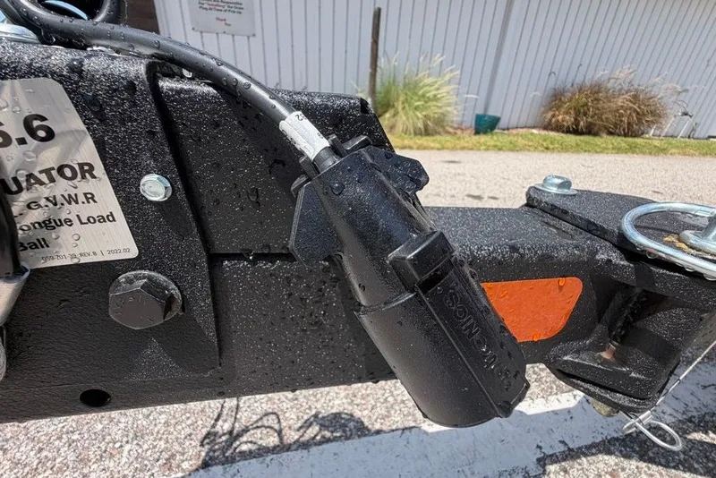 Slide: The Image of Trailer hitch detail on 2027 Tracker Grizzly 1860 CC, featuring connector and safety components. - 68