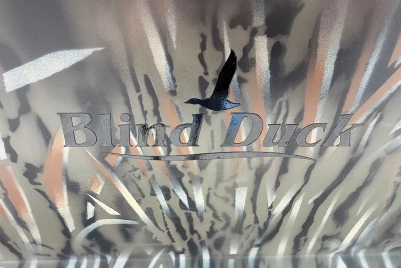 Slide: The Image of "Blind Duck" logo on camo background, 2027 Tracker Grizzly 1860 CC boat. - 69