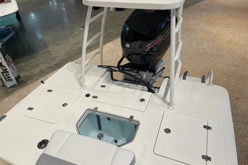 Slide: The Image of 2026 Mako 18 Pro Skiff boat with Mercury engine, showcasing deck and storage compartments. - 4