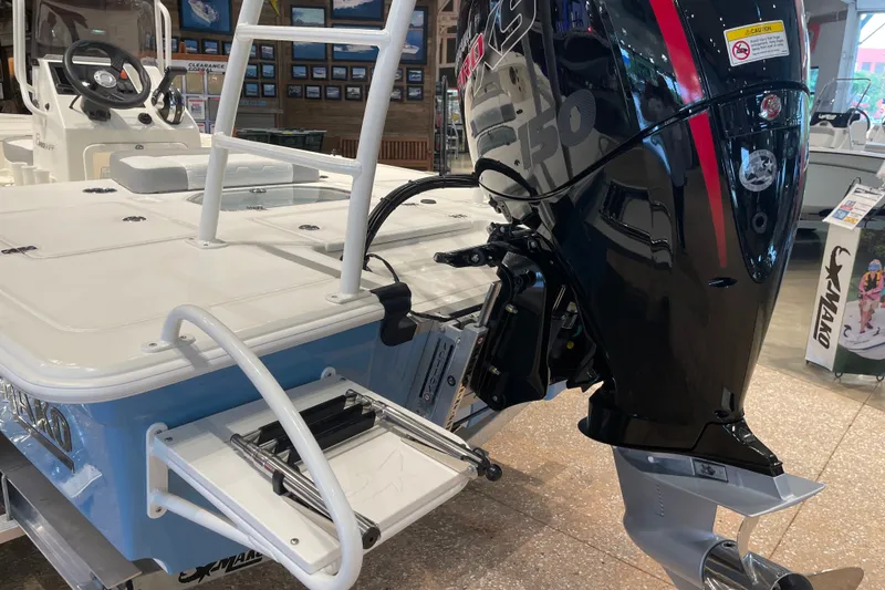 Slide: The Image of 2026 Mako 18 Pro Skiff boat with powerful outboard motor in showroom display. - 8
