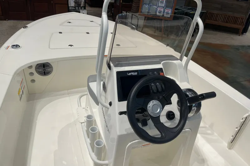 Slide: The Image of 2026 Mako 18 Pro Skiff boat interior with steering wheel and control panel. - 3