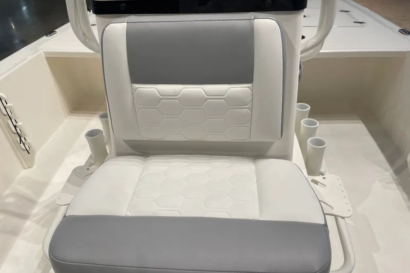 Slide: The Image of 2026 Mako 18 Pro Skiff boat seat with hexagonal pattern and cup holders. - 6