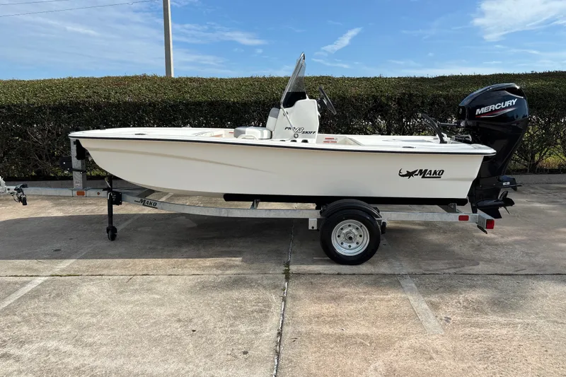 The Image of 2026 Mako Pro Skiff 13 CC boat on trailer with Mercury outboard motor. - 0