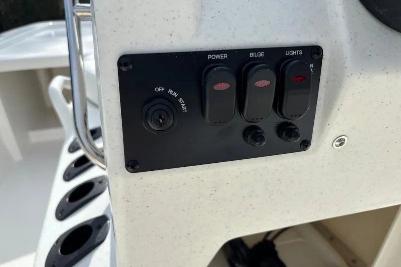 Slide: The Image of Control panel of 2026 Mako Pro Skiff 13 CC boat with switches and ignition. - 14