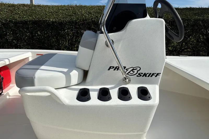 Slide: The Image of 2026 Mako Pro Skiff 13 CC boat interior with steering console and seating. - 9