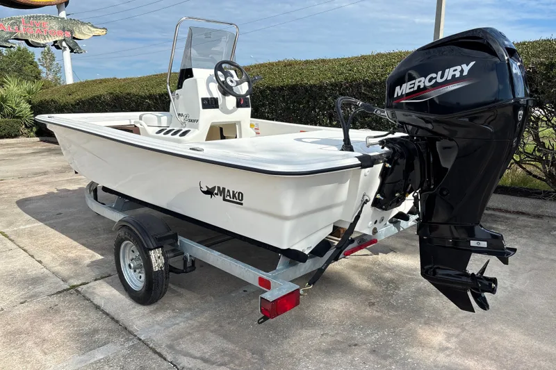 Slide: The Image of 2026 Mako Pro Skiff 13 CC boat with Mercury engine on trailer. - 2