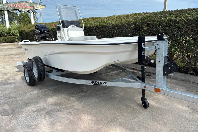 Slide: The Image of 2026 Mako Pro Skiff 13 CC on trailer, parked outdoors, featuring sleek design and compact size. - 4