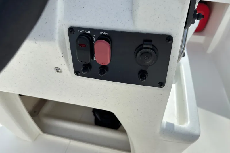Slide: The Image of Control panel of 2026 Mako Pro Skiff 13 CC boat with switches and 12V outlet. - 11