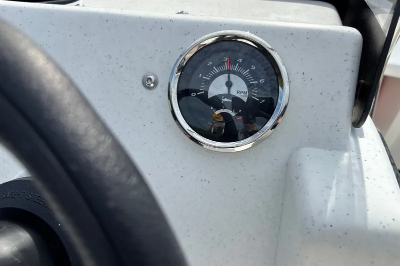 Slide: The Image of Close-up of RPM gauge on 2026 Mako Pro Skiff 13 CC boat dashboard. - 13