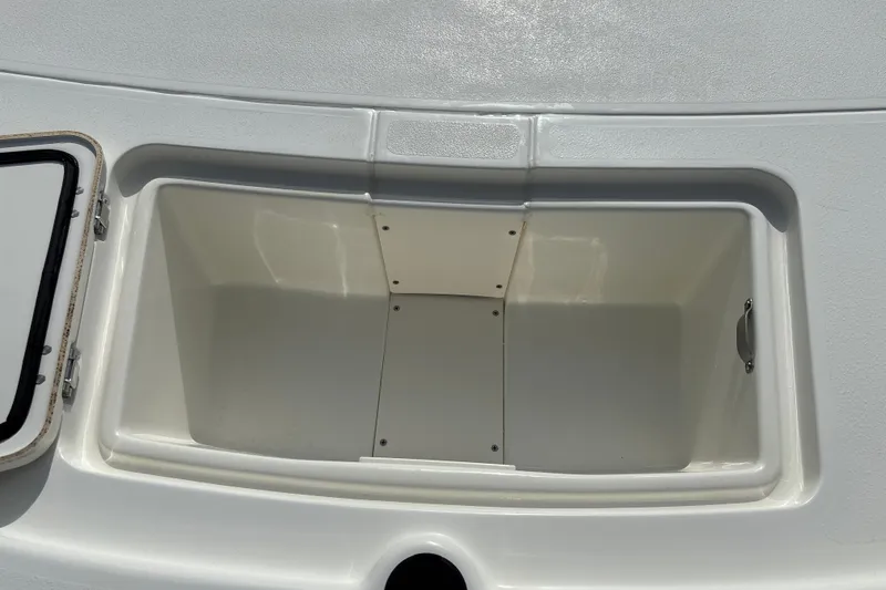 Slide: The Image of Open storage compartment on 2026 Mako Pro Skiff 13 CC boat. - 16