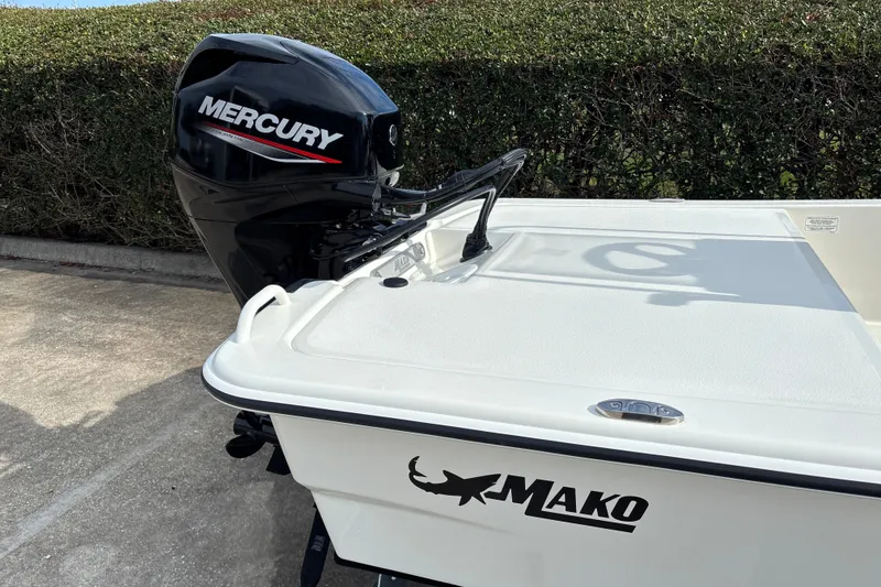 Slide: The Image of 2026 Mako Pro Skiff 13 CC with Mercury outboard motor, parked on concrete. - 8