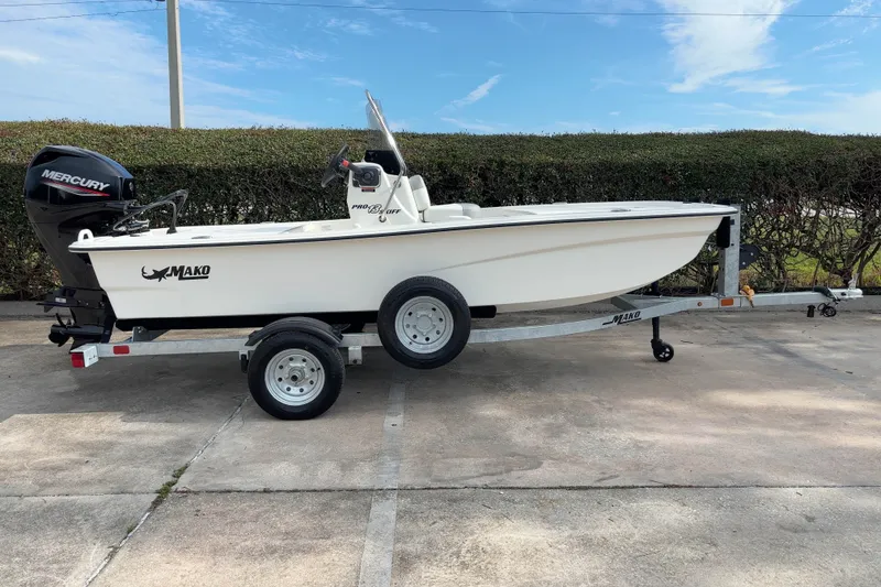 Slide: The Image of 2026 Mako Pro Skiff 13 CC boat on trailer, featuring Mercury outboard motor. - 3