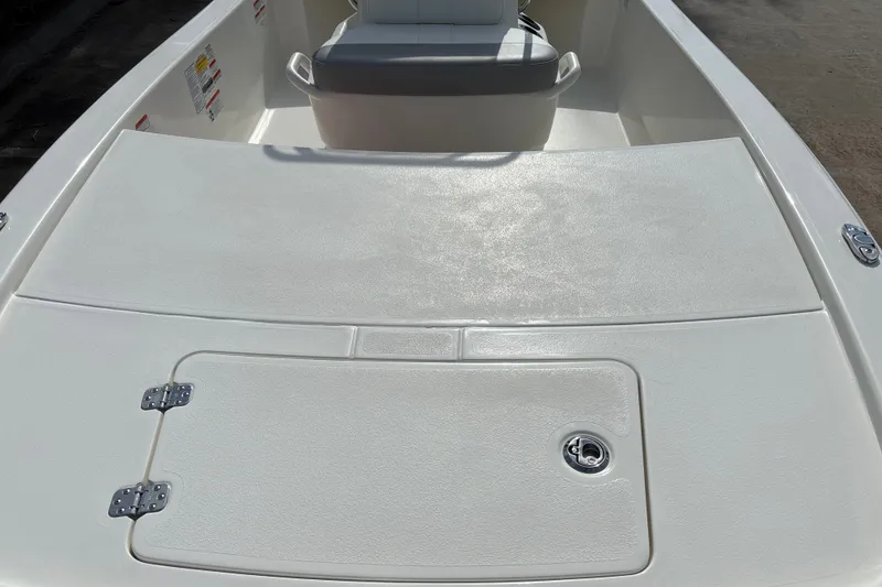 Slide: The Image of 2026 Mako Pro Skiff 13 CC boat interior with storage compartment and seating. - 15