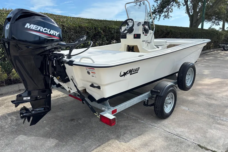 Slide: The Image of 2026 Mako Pro Skiff 13 CC boat on trailer with Mercury outboard motor. - 5