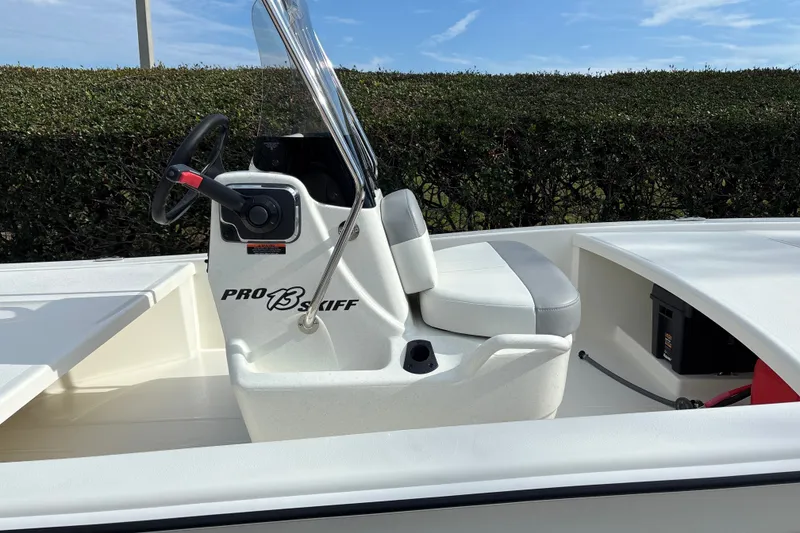 Slide: The Image of 2026 Mako Pro Skiff 13 CC boat interior with steering console and seating. - 10