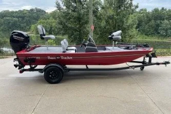 The Image of 2027 Tracker Bass Tracker Classic XL boat on trailer, parked outdoors. - 0