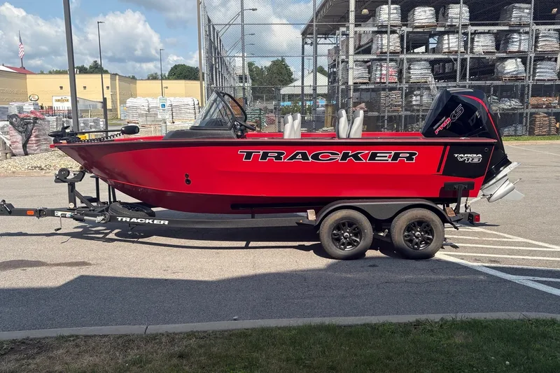 The Image of 2027 Tracker Targa V-18 WT boat on trailer, vibrant red, parked outdoors. - 0