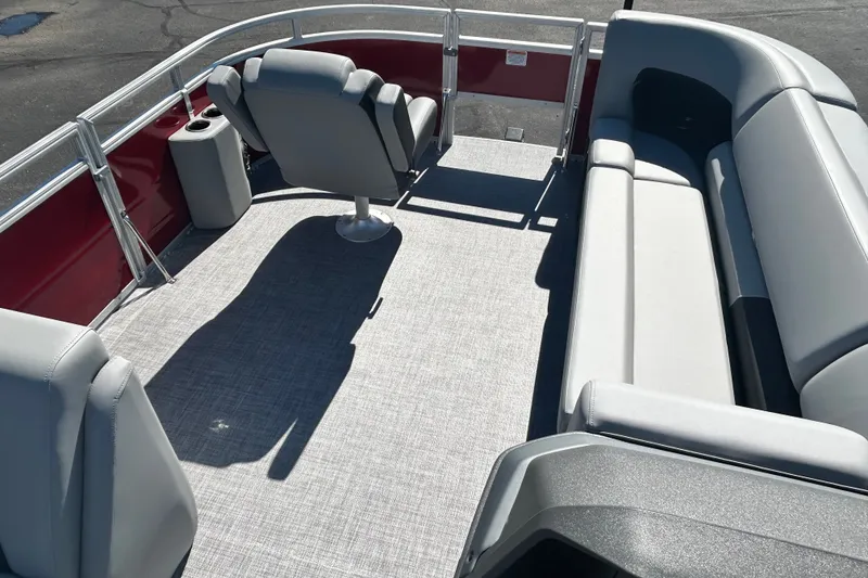 Slide: The Image of 2027 Sun Tracker SportFish 20 DLX pontoon boat interior with gray seating and red accents. - 15