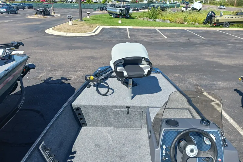 Slide: The Image of 2027 Tracker Bass Tracker Classic XL boat in parking lot, featuring steering console and seating. - 13