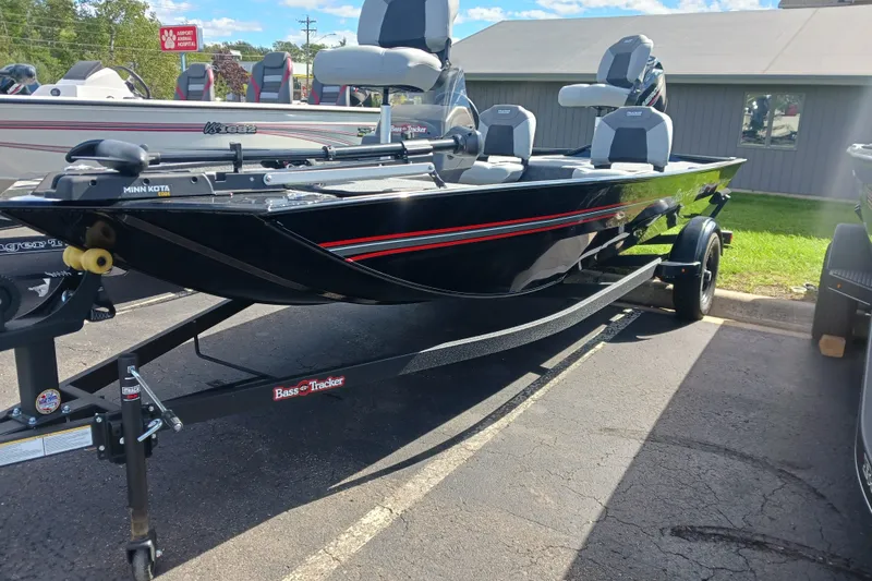 The Image of 2027 Tracker Bass Tracker Classic XL boat on trailer, parked outdoors. - 0
