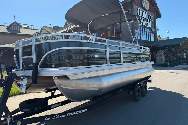 Slide: The Image of 2027 Sun Tracker SportFish 20 DLX pontoon boat on trailer outside Outdoor World store. - 13