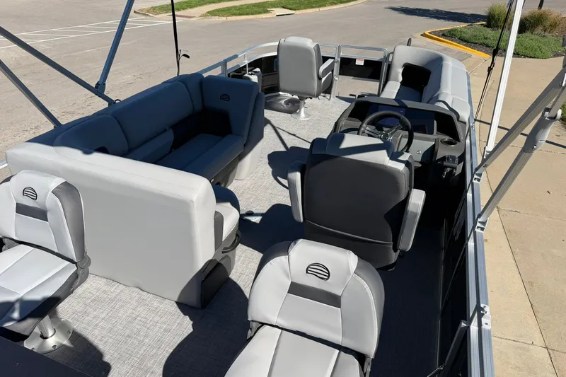 Slide: The Image of 2027 Sun Tracker SportFish 20 DLX pontoon boat interior with seating and steering console. - 29