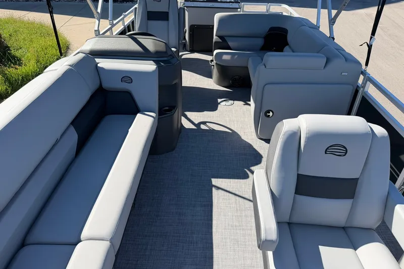 Slide: The Image of 2027 Sun Tracker SportFish 20 DLX pontoon boat interior with gray seating and spacious layout. - 16