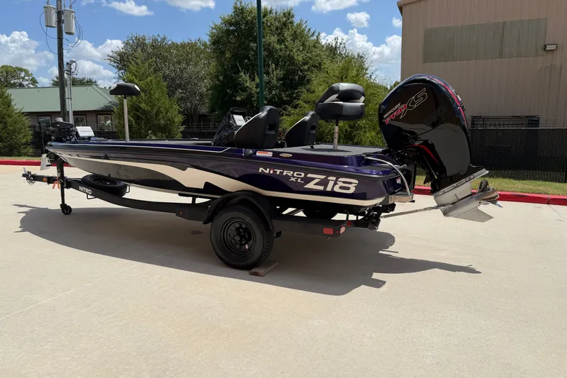 Slide: The Image of 2027 Nitro Z18 XL Pro boat on trailer, parked outdoors under clear sky. - 2