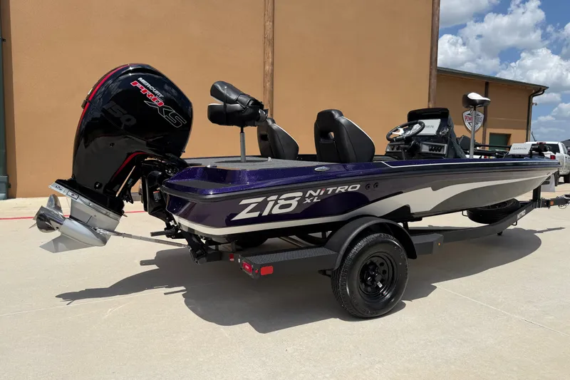 Slide: The Image of 2027 Nitro Z18 XL Pro boat with Mercury engine, parked outdoors on a sunny day. - 10
