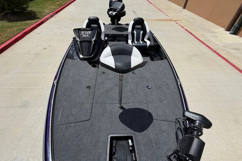 Slide: The Image of 2027 Nitro Z18 XL Pro boat with seating and Garmin equipment on a concrete surface. - 8