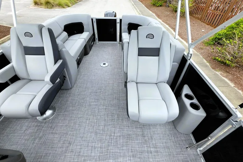Slide: The Image of 2027 Sun Tracker Party Barge 22 DLX interior with gray seating and cup holders. - 17