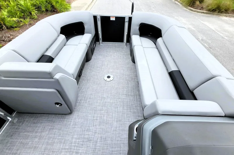 Slide: The Image of 2027 Sun Tracker Party Barge 22 DLX interior with spacious gray seating and modern design. - 18