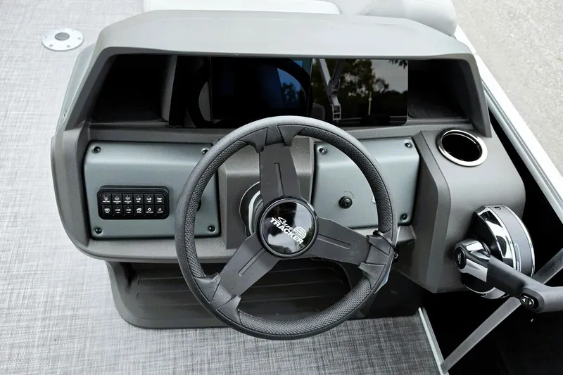Slide: The Image of Steering console of 2027 Sun Tracker Party Barge 22 DLX with modern controls and cup holder. - 13