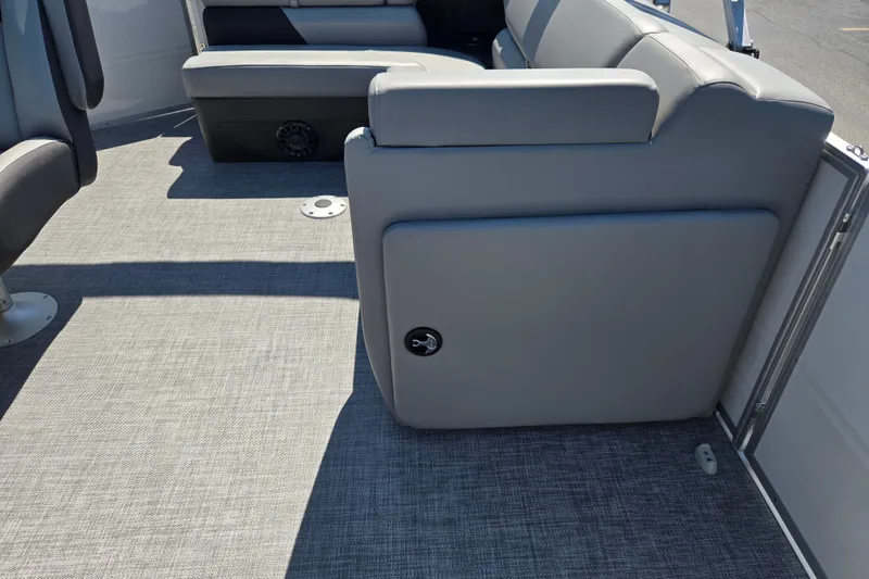 Slide: The Image of 2027 Sun Tracker Party Barge 20 DLX interior with gray seating and flooring. - 14