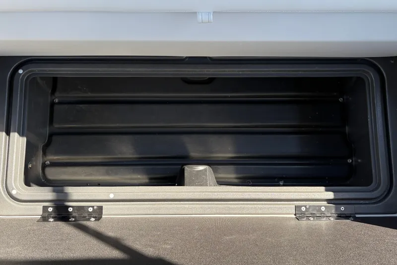 Slide: The Image of Storage compartment of 2027 Sun Tracker Fishin' Barge 22 DLX, open and empty. - 30