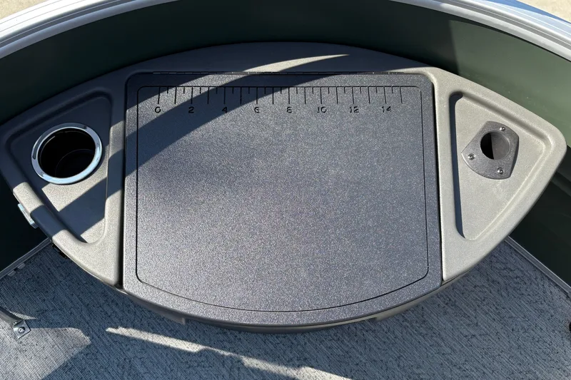 Slide: The Image of 2027 Sun Tracker Fishin' Barge 22 DLX deck with measuring board and cup holder. - 47
