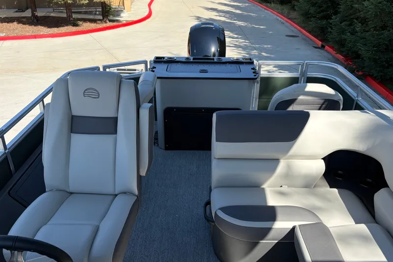 Slide: The Image of 2027 Sun Tracker Fishin' Barge 22 DLX interior with seating and motor view. - 27