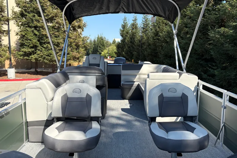 Slide: The Image of 2027 Sun Tracker Fishin' Barge 22 DLX pontoon boat interior with seating and canopy. - 14