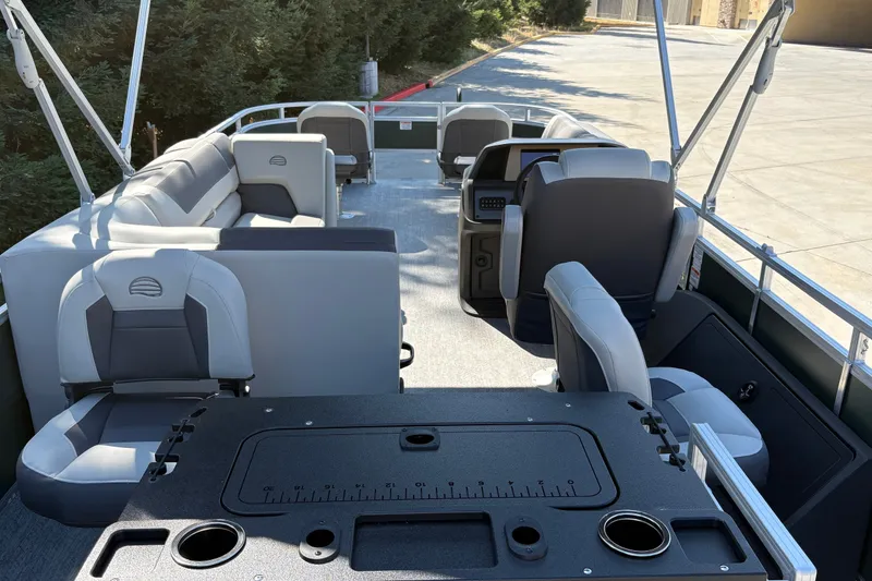 Slide: The Image of 2027 Sun Tracker Fishin' Barge 22 DLX interior with seating and fishing station. - 15