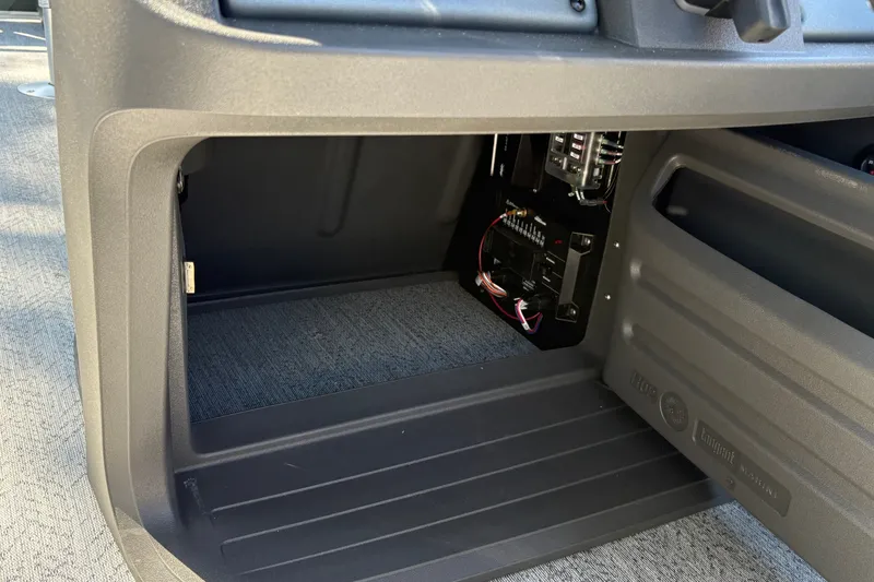 Slide: The Image of Interior view of 2027 Sun Tracker Fishin' Barge 22 DLX, showcasing storage compartment and wiring. - 34