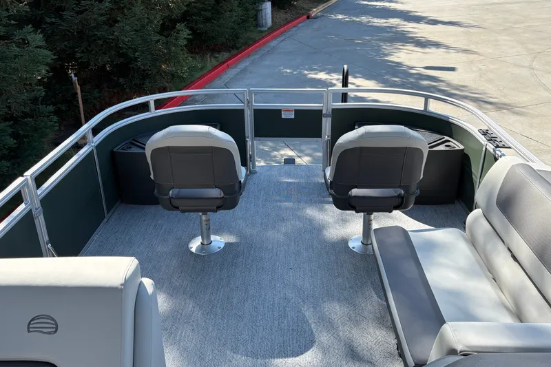 Slide: The Image of 2027 Sun Tracker Fishin' Barge 22 DLX interior with seating and fishing chairs. - 13