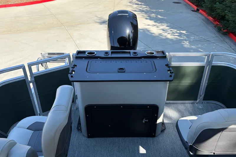 Slide: The Image of 2027 Sun Tracker Fishin' Barge 22 DLX interior with seating and fishing station. - 18