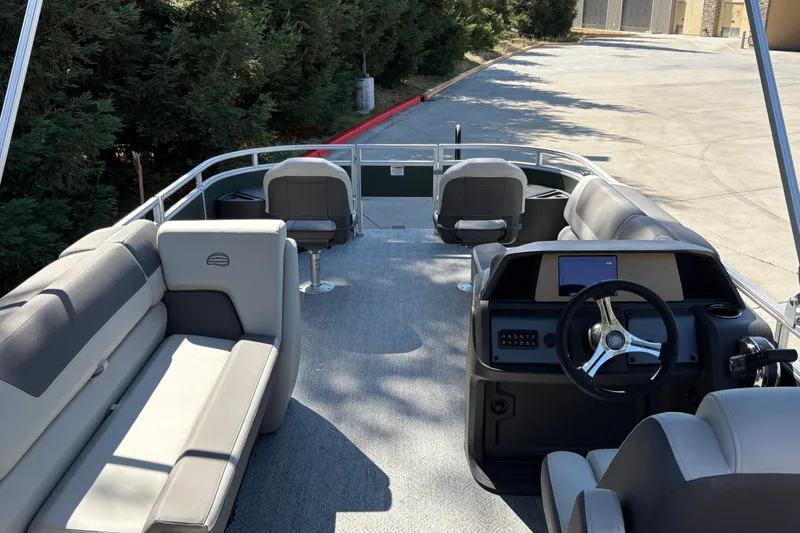 Slide: The Image of 2027 Sun Tracker Fishin' Barge 22 DLX interior with seating and steering console. - 16
